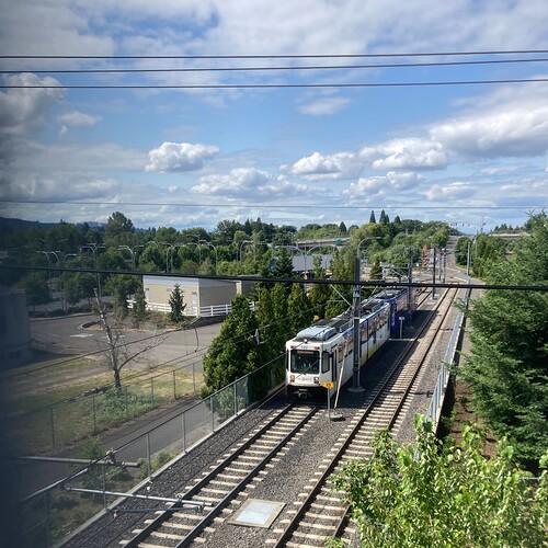 Type 1 #122 leads a southbound train away from the Tacoma & 99E station